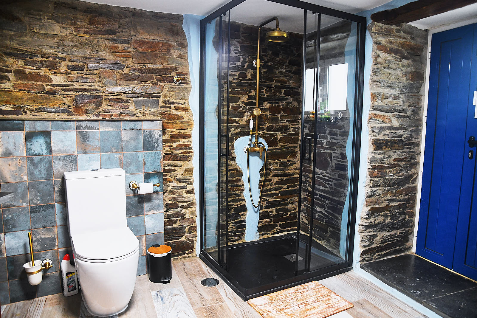 Bathroom with glass shower, stone sink and toilet