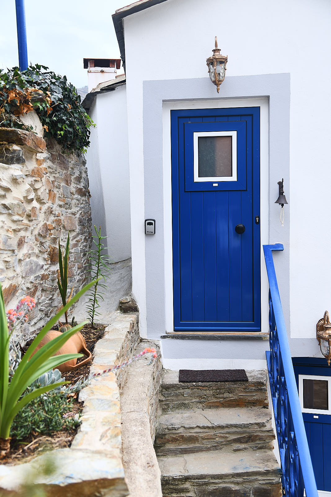 Casa da Égua blue entrance door approached by stone steps